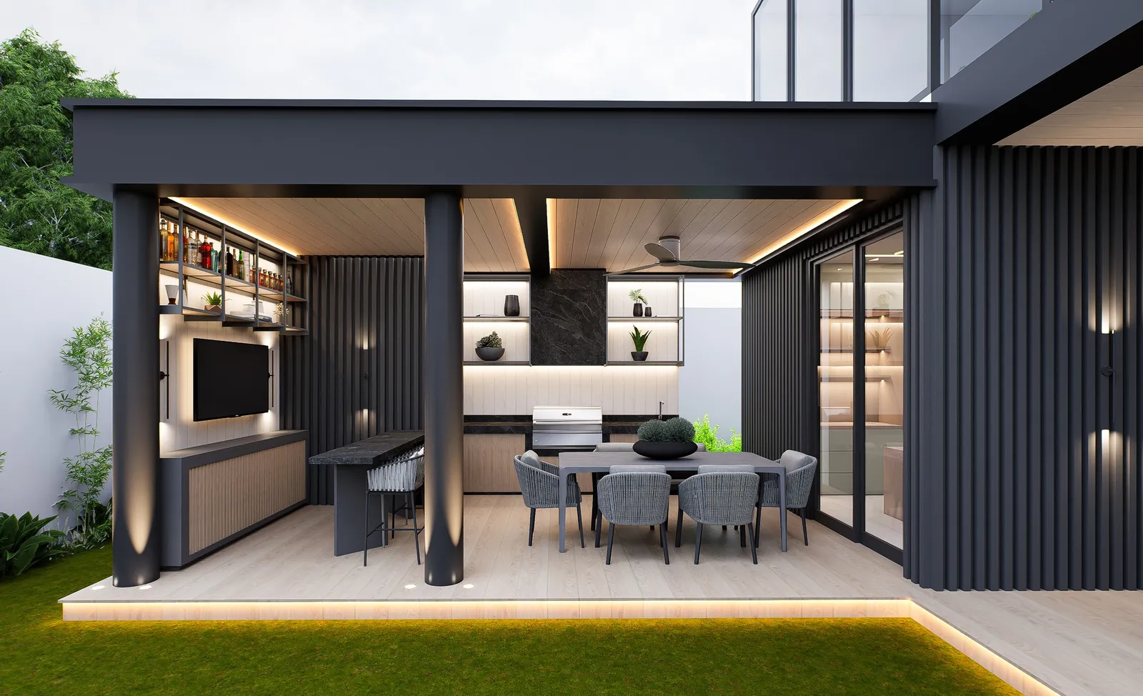 Espacio cubierto y moderno con zona de comedor, área de cocina y entretenimiento, iluminado con luces integradas.